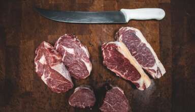 sliced meat beside silver knife